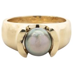 Designer: custom design Material: 18k yellow gold Tahitian Pearl: 9mm Ring Size: 8 ½ (please allow two additional shipping days for sizing requests) Dimensions: ring top measures 16.85mm by 15.54mm Weight: 12.12 grams Tahitian Pearl Ring Unique, Luxury Gold Rings With Tahitian Pearl, Luxury Tahitian Pearl Ring, Round Shape, Luxury Tahitian Pearl Rings Fine Jewelry, Luxury Fine Jewelry Tahitian Pearl Rings, Luxury Tahitian Pearl Round Rings, Luxury Tahitian Pearl Classic Ring, Luxury Yellow Gold Ring With Tahitian Pearl, Luxury Tahitian Pearl Rings In Fine Jewelry Style