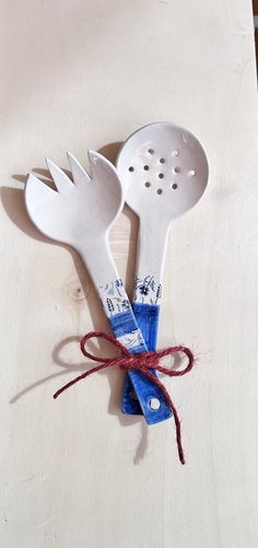 two white utensils tied up with twine