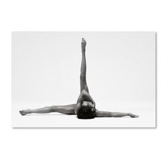 a black and white photo of a woman doing a handstand in the air