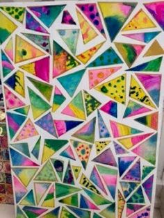 an art project made out of stained glass and paper with colorful shapes on it, including triangles