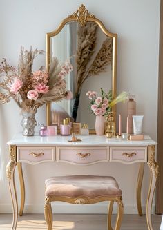 a dressing table with flowers and candles on it