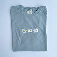 "Retro Daisy Embroidered T Shirt - Comfort Colors Unisex Flowers Shirt - Gift For Her - Shirt Info - -Comfort Colors 1717 Tee in Granite -6.1 oz., 100% ring spun USA cotton -Preshrunk, soft-washed, garment-dyed fabric -Made with sustainably and fairly grown USA cotton and sewn with USA cotton thread -Twill taped shoulder-to-shoulder -Set-in sleeves -Double-needle stitched sleeves and bottom hem -1\" ribbed collar with double-needle topstitched neckline -Comfort colors uses 50% less water than traditional pigment dye processes on pigment dye and color blast garments -Comfort colors®, through Gildan's community investment program, supports education, the environment, humanitarian aid and active living in the communities we do business in Care instructions: -Machine cold wash, inside out, wit Blue Floral Embroidery Short Sleeve T-shirt, Casual Daisy Print Short Sleeve T-shirt, Blue Floral Embroidered Short Sleeve T-shirt, Embroidered T Shirt, Spring Daisy Print Short Sleeve T-shirt, Humanitarian Aid, Spring Daisy Print Relaxed Fit T-shirt, Pet Allergies, Retro Daisy