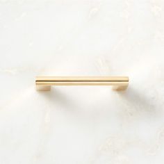 a gold handle on a white marble surface