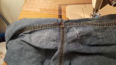 the jeans are being sewn together with a sewing machine