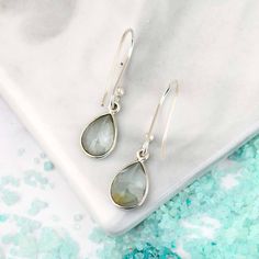 Sleek and timeless, these Aquamarine teardrop earrings are a must-have in your jewelry collection. The delicate blue-green gems dangle elegantly from sterling silver hooks, adding a touch of magic to any outfit. The perfect "go-to" accessory for any occasion*Our jewelry features natural, genuine gemstones, ensuring each piece is unique and one-of-a-kind. Please note that, as no two gemstones are identical, the jewelry you receive may vary from the photos.Material: Genuine Sterling Silver 92.5Gem Sterling Silver Gemstone Teardrop Earrings, Sterling Silver Briolette Teardrop Gemstone Earrings, Sterling Silver Long Drop Teardrop Gemstone Earrings, Sterling Silver Teardrop Earrings With French Hook, Teardrop Pendant Earrings With French Hook For Gift, Teardrop Earrings With French Hook For Gift, Teardrop Earrings With French Hook As Gift, Gift Teardrop Earrings With French Hook, Silver Gemstone Teardrop Long Drop Earrings