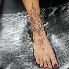 a woman's foot with a tattoo on it