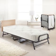 a bed sitting on top of a metal frame