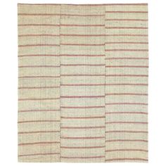 a beige and red striped rug on a white background with two rows of vertical stripes