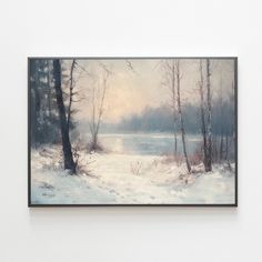 a painting hanging on the wall in front of a white wall with trees and snow