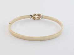 "Fabulous 14k Gold Love Knot Bangle Bracelet!! Material: Real 14k gold , Stamped 14k Weight: 7.10 grams Length: 7\" long Width: 10 mm wide on the knot and 5 mm wide on the tube Finish: Shiny yellow and white gold Closure: Hinged , Snap closure Gift box included Images may be enlarges to show details.Please pay attention to the photos and read description before the purchase. I ask you earnestly to make sure about measurements such as size , thickness, and length. Should you have any concerns or Gold-tone Polished Bangle For Formal Occasions, Gold-tone Bangle With Polished Finish For Formal Occasions, Gold Dual-tone Bangle As A Gift, Modern Gold-tone Bangle With Polished Finish, Gold-tone Polished Finish Bangle For Gift, Gold Heart Locket, Knot Bangle, Engraved Locket, Heart Locket