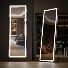 a large mirror sitting on top of a wooden floor next to a living room filled with furniture