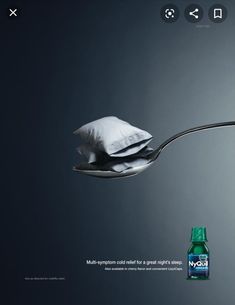 a spoon with a pillow on it and a bottle of mouthwash sitting next to it