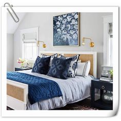 a bedroom with white walls and blue bedding