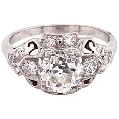 Vintage 1950s White Gold European Cut Diamond Filigree Ring - The center Old European Cut diamond weighs 1.20ct and is an I color and SI1 clarity. The diamond is set prominently in square fishtail prongs with 8 full cut diamonds accented on the ring. The hand carved filigree design makes a simple and elegant statement. The ring is a size US 5.5 and can be sized. The ring is stamped 14k. Filigree Design, European Cut Diamonds, Filigree Ring, Ring Vintage, Cluster Ring, Cocktail Rings, Vintage 1950s, The Hand, Ring Verlobung