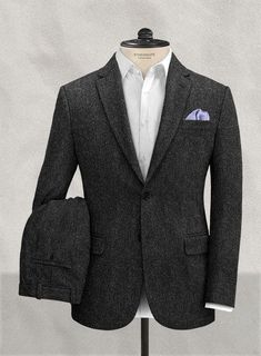 Keep your profile defined with our Harris Tweed Suit, which retains its heritage of practicality and longevity while extolling all the qualities and virtues of genuinely luxurious fabric. It's made from 100% wool cloth and features classic design elements giving a vintage feel. This charcoal-colored suit uses a herringbone weave known for its broken zigzag pattern for subtle interest. #studiosuits #mensclothingstyle #harristweed #charcoal #gray #solid #vintage #luxurious #dapper Luxury Classic Suit With Notch Lapel, Luxury Menswear-inspired Tweed Jacket For Formal Occasions, Luxury Menswear-inspired Tweed Jacket For Office, Luxury Tweed Suits For Winter, Luxury Brown Classic Tuxedo, Luxury Brown Tuxedo, Luxury Classic Suits With Notch Lapel, Luxury Tweed Suits For Fall, Luxury Winter Suits With Buttons