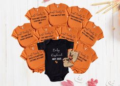 PRODUCT  - All the t-shirts will be BURNT ORANGE in color and you can specify in the personalization box if you want the baby's bodysuit to either be BLACK or WHITE(. Please check out other variations of this group design here): https://www.etsy.com/shop/GIFTABLEByBetty?ref=dashboard-header&section_id=50406437 - This is a regular relaxed fit, to achieve the oversize look, please select 1-2 sizes  above your usual size.  - This t shirt design will be made with DTF(Direct to Fabric) print method. - The price is for a single t-shirt. - Please find color charts  and size chart in the listing photos.  - If you enter wrong address with your order, we will try to help you if you message and only if the item has not been made (within 12 hours after placing order). - Please note that the actual col Surprise Pregnancy Announcement, Baby Shower Shirts, Dashboard Header, Baby Baskets, Pregnancy Announcement Shirt, Matching Baby, Find Color, Halloween Theme, Shirts Funny