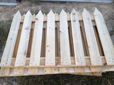 a wooden pallet sitting on top of grass