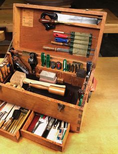 an old wooden tool box filled with lots of different types of tools and gadgets