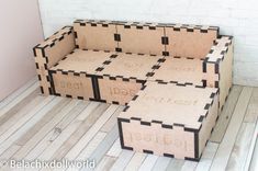 three cardboard boxes sitting on top of a wooden floor