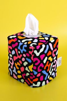 a tissue box covered in multicolored animal print