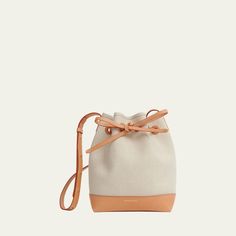 Mansur Gavriel bucket bag in canvas linen and cotton  Adjustable crossbody strap, 24.5"L Self-tie drawstring closure  Approx. 9.8"H x 7"W x 4.8"D Made in Italy Luxury Canvas Bucket Bag With Adjustable Strap, Modern Canvas Crossbody Bucket Bag, Canvas Crossbody Bucket Bag With Leather Trim, Beige Canvas Bucket Bag With Detachable Strap, Beige Bucket Bag With Canvas Lining, Canvas Bucket Bag With Detachable Handle, Cream Canvas Bucket Bag With Adjustable Strap, Luxury Canvas Bucket Bag With Detachable Handle, Canvas Bucket Bag With Canvas Lining