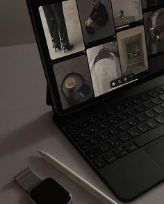 an open laptop computer sitting on top of a white table next to a cell phone