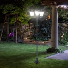 a lamp post in the middle of a yard at night