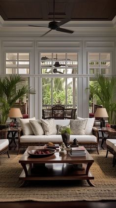 a living room filled with lots of furniture and plants on top of a wooden table