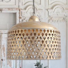 a lamp that is on top of a table next to a potted plant in front of an old door