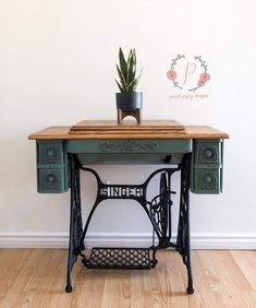 an old sewing machine with a plant on top