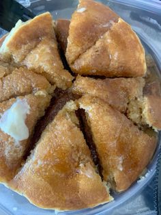 a cake in a plastic container with some icing on the top and one slice missing