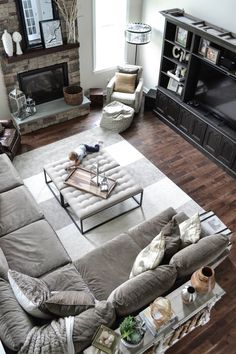 a living room filled with furniture and a fire place in the middle of the room