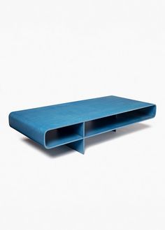 a blue shelf sitting on top of a white wall