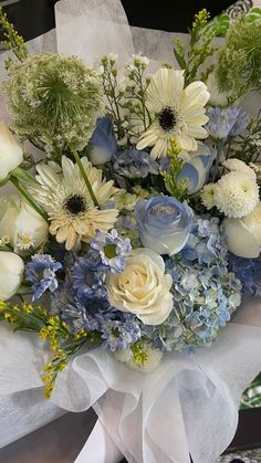 a bouquet of white and blue flowers