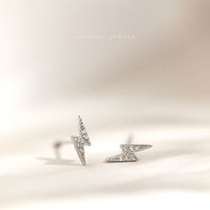 Dainty earrings. A perfect gift for birthday, anniversary, bridesmaids, graduation, friendship, sisters. ♡ Sold as one piece or a pair ♡ The lightning is 9-10 mm high ♡ Choose from two styles: butterfly end: post thickness is 20g (0.8mm), post length is 9mm with butterfly end attached, butterfly end is 4mm ball end: post thickness is 19g (0.9mm), post length is 6-7mm with ball end attached , ball end is 3.5mm Measurements are approximate only ♡ Available in thick 14k gold plated or rhodium plate White Diamond Pierced Earrings For Party, Minimalist Sparkling Jewelry For Wedding, Tiny Minimalist Earrings For Wedding, Minimalist Pierced Diamond Earrings For Wedding, Dainty Silver Crystal Earrings For Anniversary, Minimalist Pierced Diamond Earrings As Gift, Minimalist Silver Earrings With Sparkling Details, Minimalist Silver Sparkling Earrings, White Sterling Silver Diamond Earrings For Gift