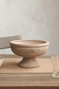 a wooden bowl sitting on top of a table