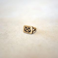 a close up of a gold ring with two crossed bones on the front and back