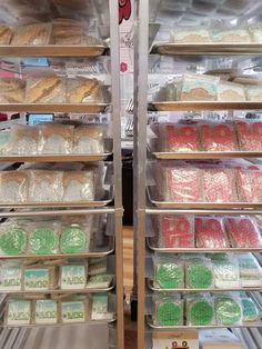 there are many different types of donuts in the display case at this bakery store