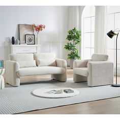 a living room with two chairs and a rug