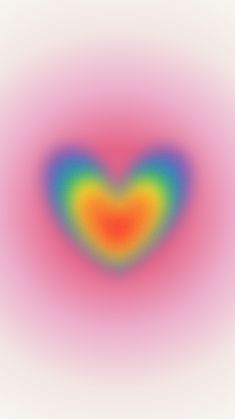 an image of a heart shaped object in the middle of a blurry background with colors