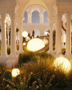 an outdoor area with white pillars and lights