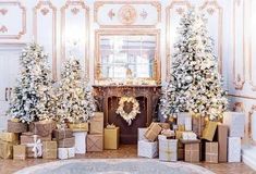 christmas trees and presents in front of a fireplace with gold trimmings on the mantle