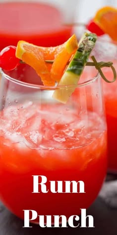 a close up of a drink in a glass with fruit on the rim and text overlay reading rum punch