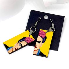 Experience the passion and inspiration of the iconic Frida Kahlo with our stunning and one-of-a-kind hand painted earrings. These unique 100% original artworks are carefully crafted and assembled by hand, from the metal jump rings to the wooden findings and hook earring. Each piece is a true work of art, made with high quality acrylic paint and protected with a glossy finish for long-lasting beauty. These gorgeous yellow earrings are lightweight and make for a truly special accessory. Perfect for any Frida fan or someone special in your life, this is a gift that will be cherished forever. DETAILS: Size: 3/4 Inch x 1.5 Inch each (without including earrings hook wires). • FREE GIFT BOX INCLUDED! Thank you for shopping with us!____________________________ * Handmade/Hand-Painted Product. Colo Frida Kahlo Earrings, Hand Painted Earrings, Mexican Jewelry, Painted Earrings, Yellow Earrings, The Passion, Girls Earrings, Hook Earrings, Jump Rings