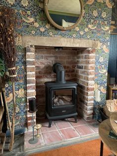 a living room with a fire place in the center and a mirror on the wall