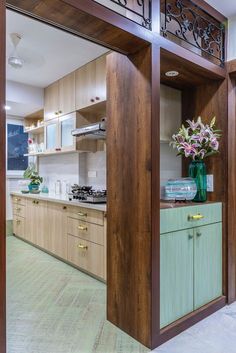 a kitchen with wooden cabinets and green vases