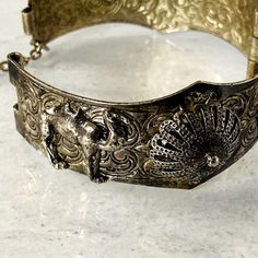 Vintage Hand Of Fatima Filigree Silver Tone Bracelet - Hinged Clamper Bangle - Applied details. Great detailed stamped design with applied camels, raised filigree domes, and the hands. This clamper bracelet fits wrists up to 7 inches snug. Inside measurement is 2 1/4 inches across, the shape is round instead of oval. It is nicely made, and unsigned. Luxury Filigree Cuff Bangle Bracelet, Luxury Antique Handmade Cuff Bracelet, Luxury Antique Silver Bracelets With Intricate Design, Luxury Ornate Bangle Cuff Bracelet, Vintage Silver Tone Braided Hinged Metal Bracelets, Jewelry Tags, Hand Of Fatima, Silver Filigree, Metal Bracelets