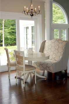 a dining room table with chairs and a chandelier