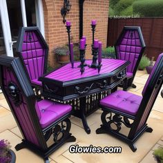 a table and chairs with purple upholstered cushions