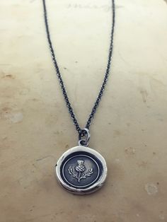 "This Scottish Thistle Wax Seal Necklace makes the perfect gift for a friend or a reminder of your Scottish heritage. Read on to learn about its symbolism and history. Scottish Thistle Wax Seal Necklace, even more beautiful in person, this silver thistle charm is the national flower of Scotland, the meaning \"No One Provokes Me With Impunity\". One thistle is said to have saved an entire Scottish army. This vintage wax seal more then likely sat forgotten in the back of desk drawer until we acqui Bookmark Keychain, Scottish Army, Scotland Thistle, Scottish Jewelry, Thistle Necklace, Xo Necklace, Wax Seal Pendant, Seal Necklace, Wax Seal Jewelry